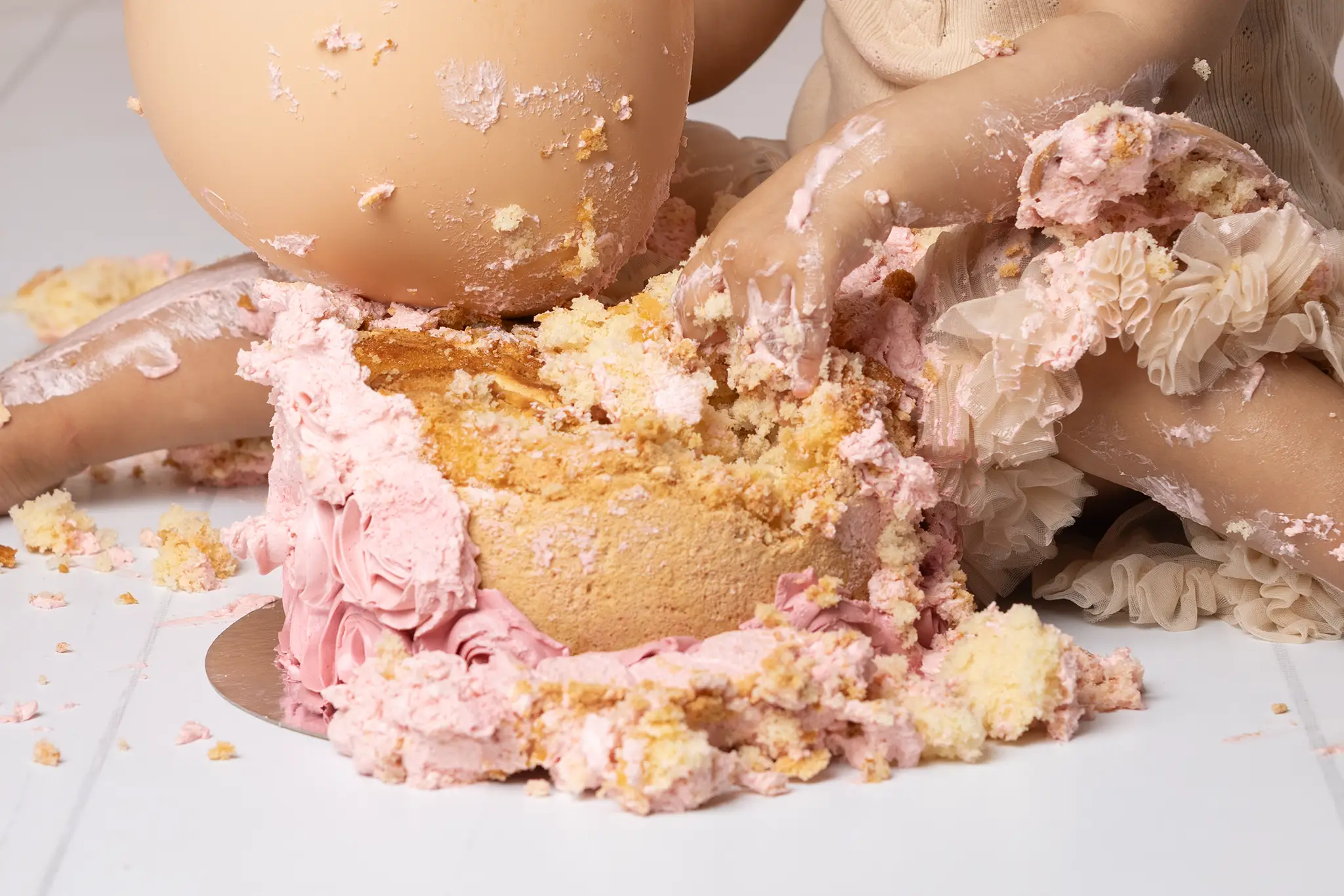 Kladd med tårta och en massa skoj En hand som gräver i en rosa tårta och kladdar för fullt.